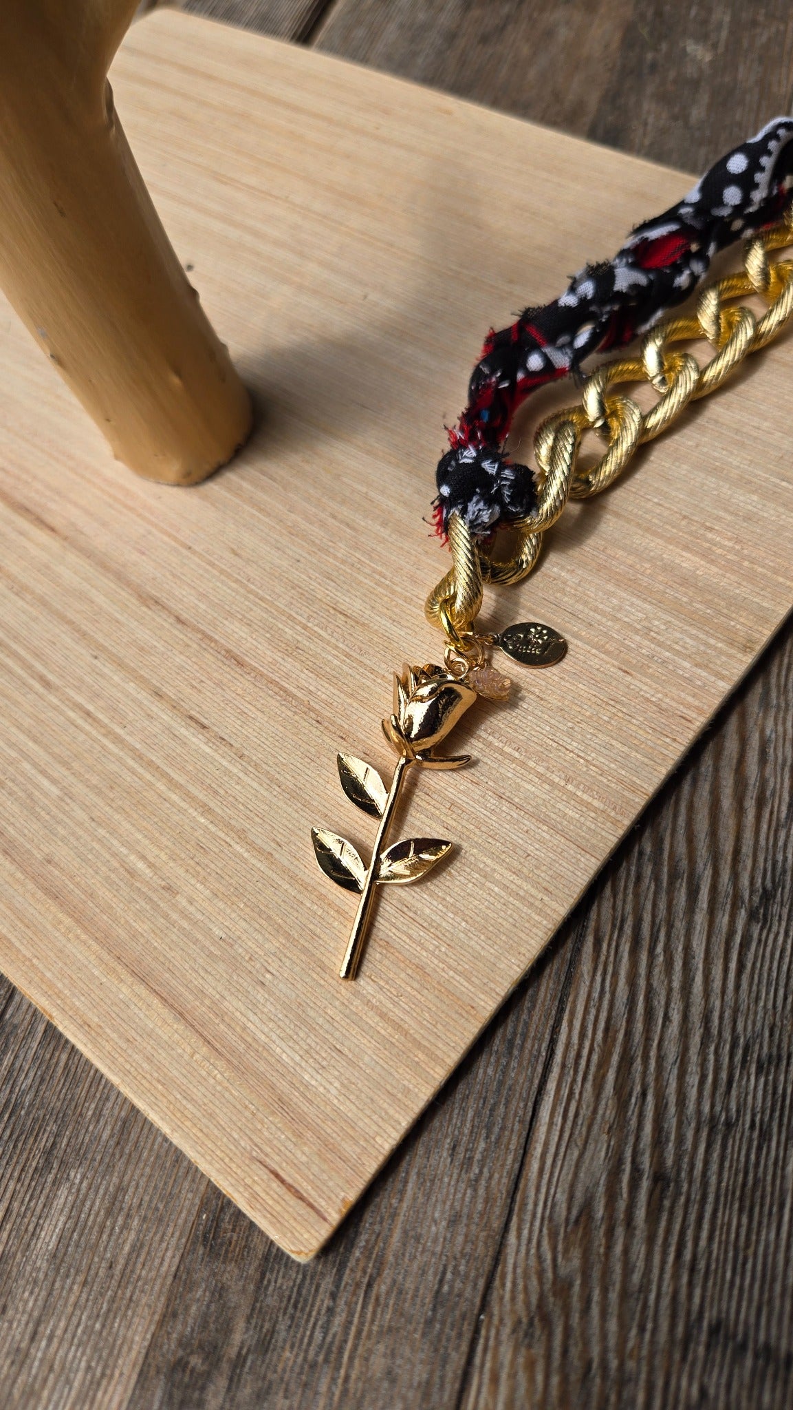 Black and red fabric gold chain necklace with flower charm detail