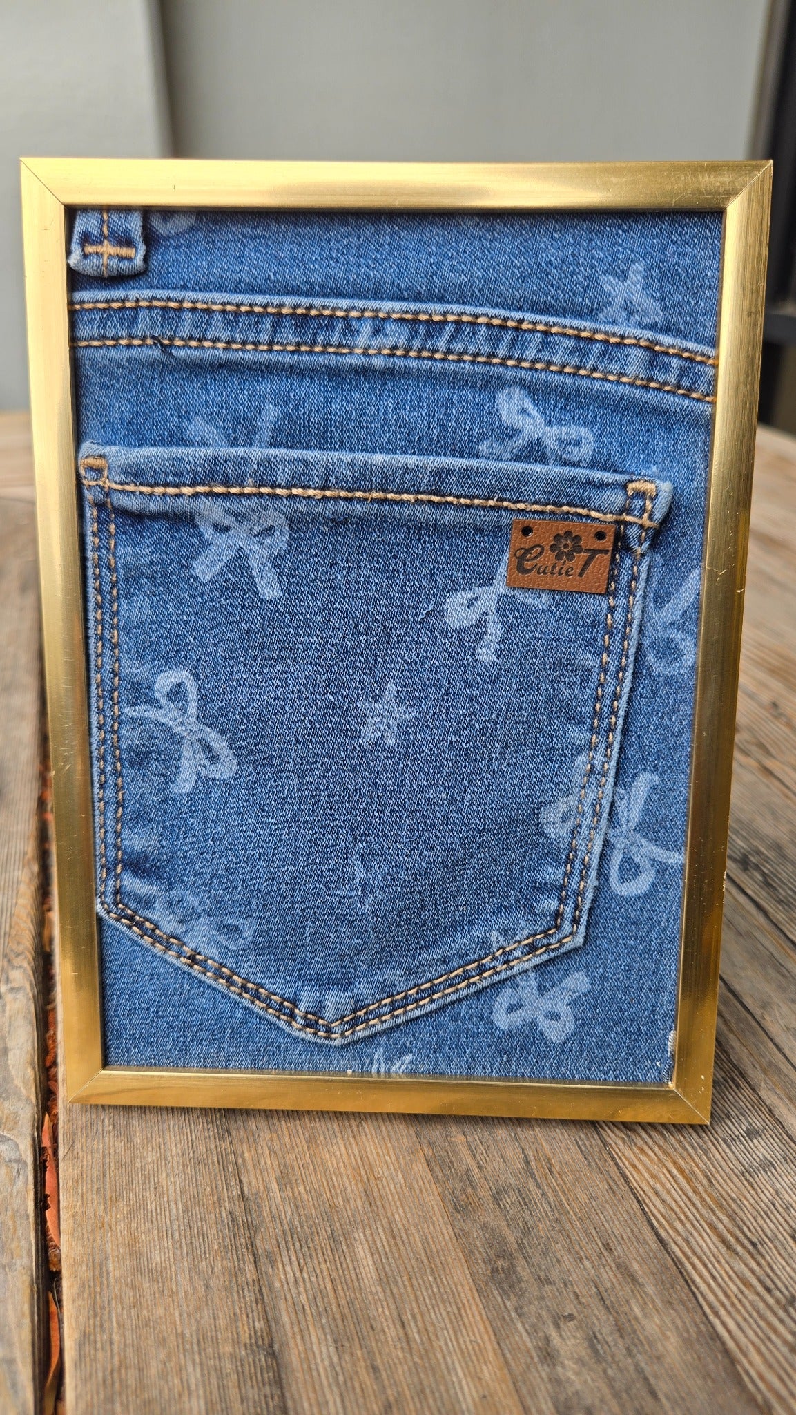 Denim pocket gold frame Cutie display