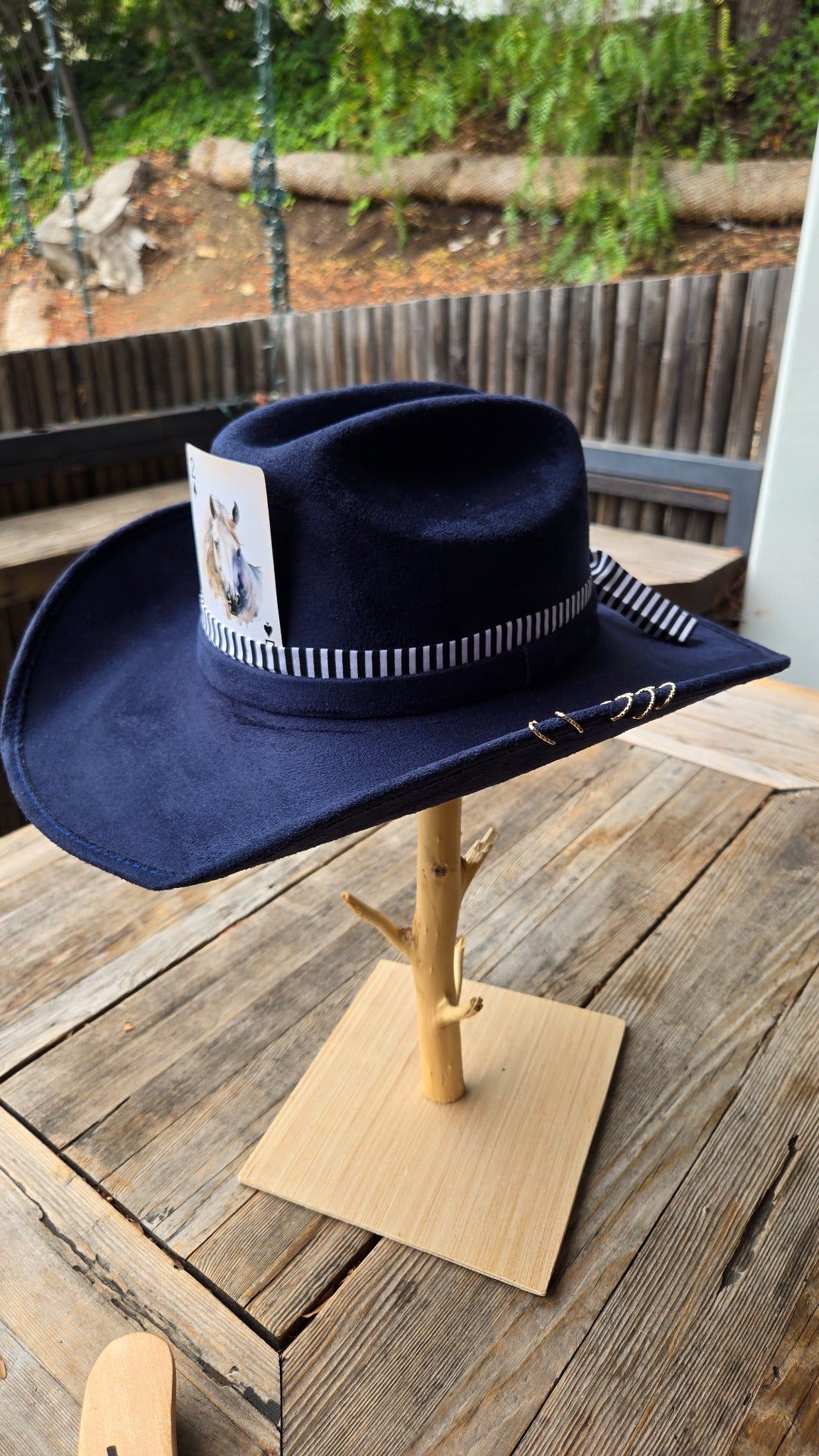 Navy western cowboy hat with striped band and horse card side view