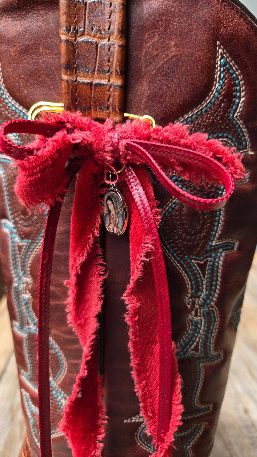 Red ribbon boot charm with small medallion detail