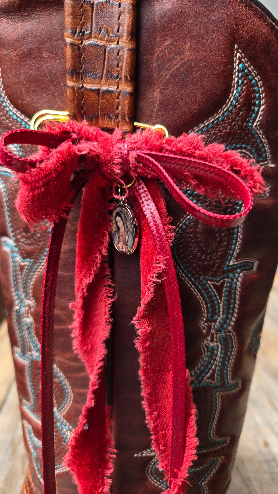 Red ribbon boot charm with small medallion detail