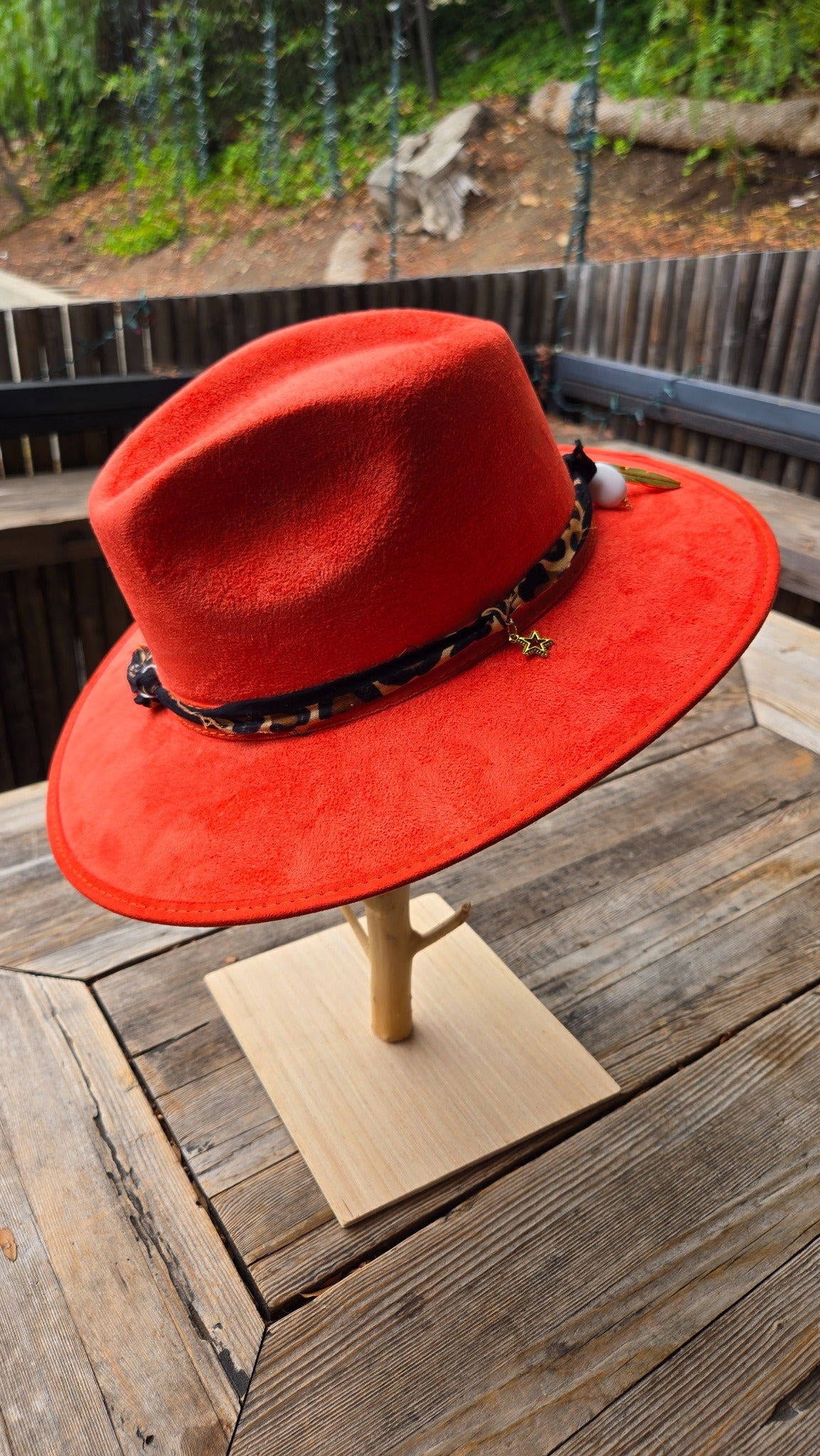 Red western cowboy hat side view with decorative scarf