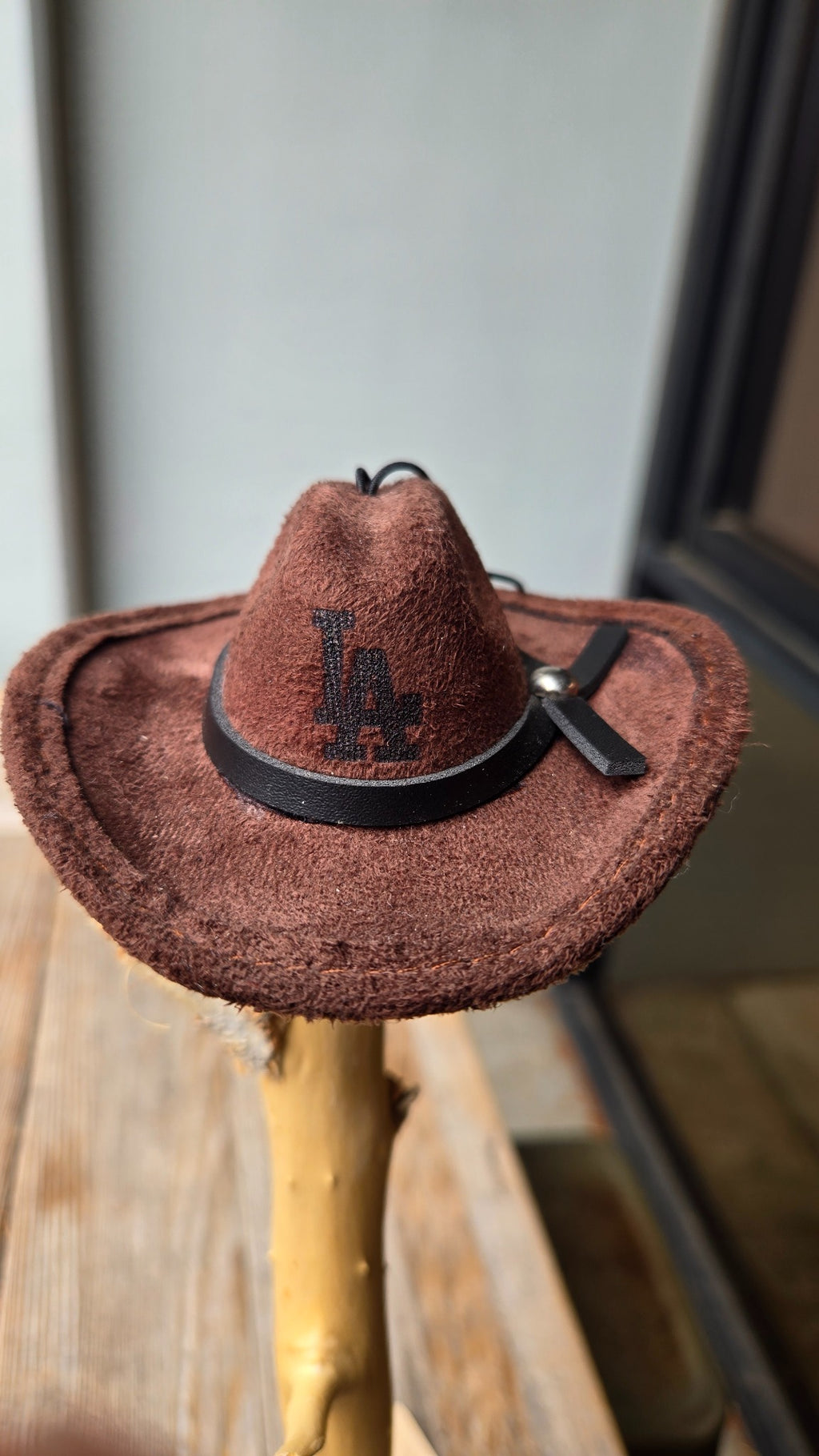 Small brown western hat with black band front view