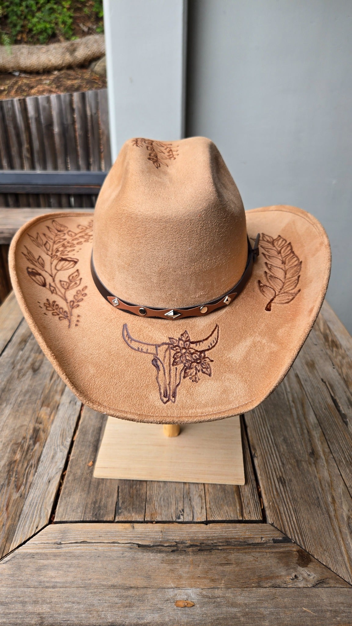 Tan western cowboy hat with botanical and skull design
