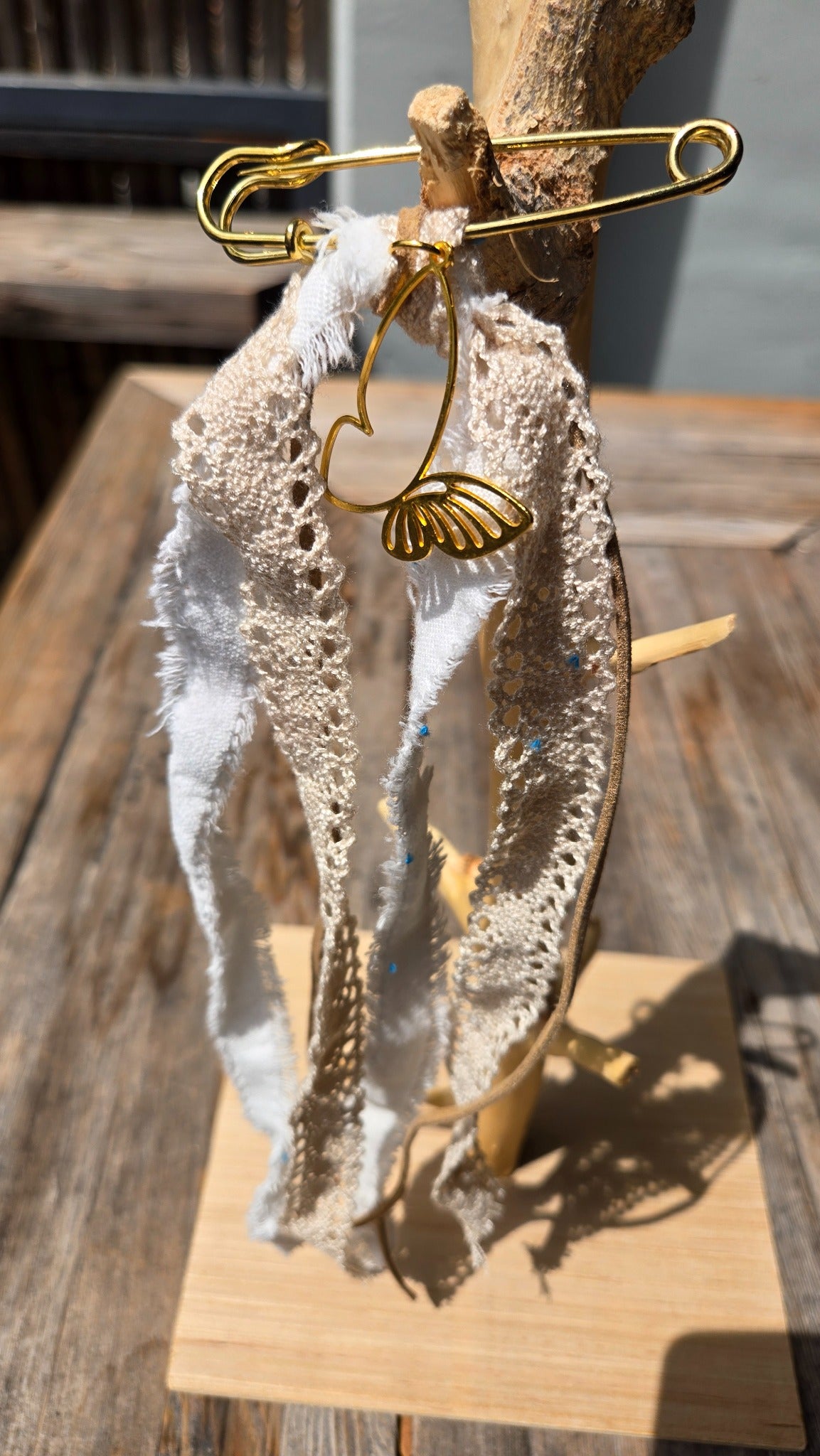 White lace accessory charm with gold butterfly detail